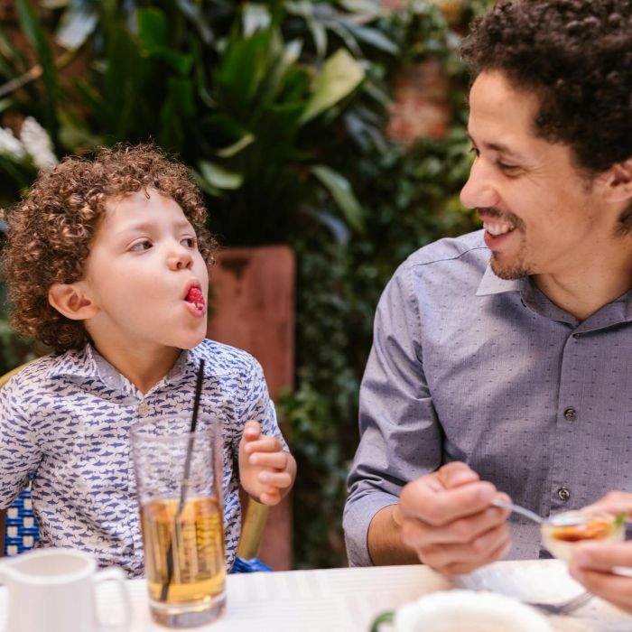 Father and son sharing a meal at a restaurant for Father's Day